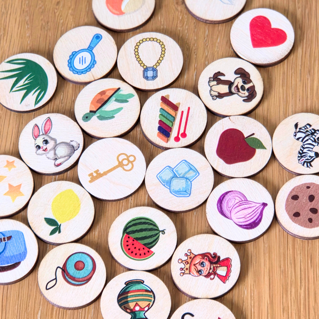 Collection of round wooden tokens with various illustrations on a wooden surface