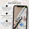 Phone displaying an alphabet learning app with wooden letters and text explaining how to play 'Alphabet Hunt'.