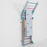 Foldable jungle gym folded to about 1 ft from the wall to save space