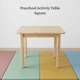 Square wooden preschool activity table on a colourful mat